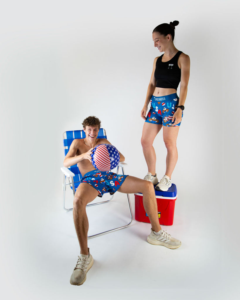 Runners are wearing the women's 3 in compression spandex shorts, and the men's 4 in split running short in the USA Pool party design. The print has bald eagles on it, american flags, USA colors such as red white and blue all over it.
