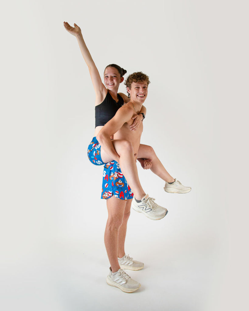 Runners are wearing the women's 3 in compression spandex shorts, and the men's 4 in split running short in the USA Pool party design. The print has bald eagles on it, american flags, USA colors such as red white and blue all over it.