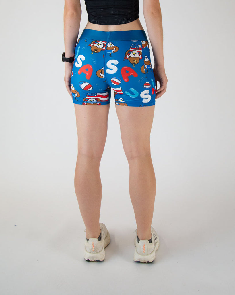 Runner is wearing ChicknLegs in the women's 3 in compression spandex shorts with side pockets. The back view is shown where there is a seam down along the back. Nicely resting on a higher waist.