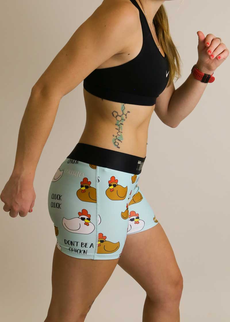 Side view of the 3 inch compression running shorts with a swaggy chickns design.
