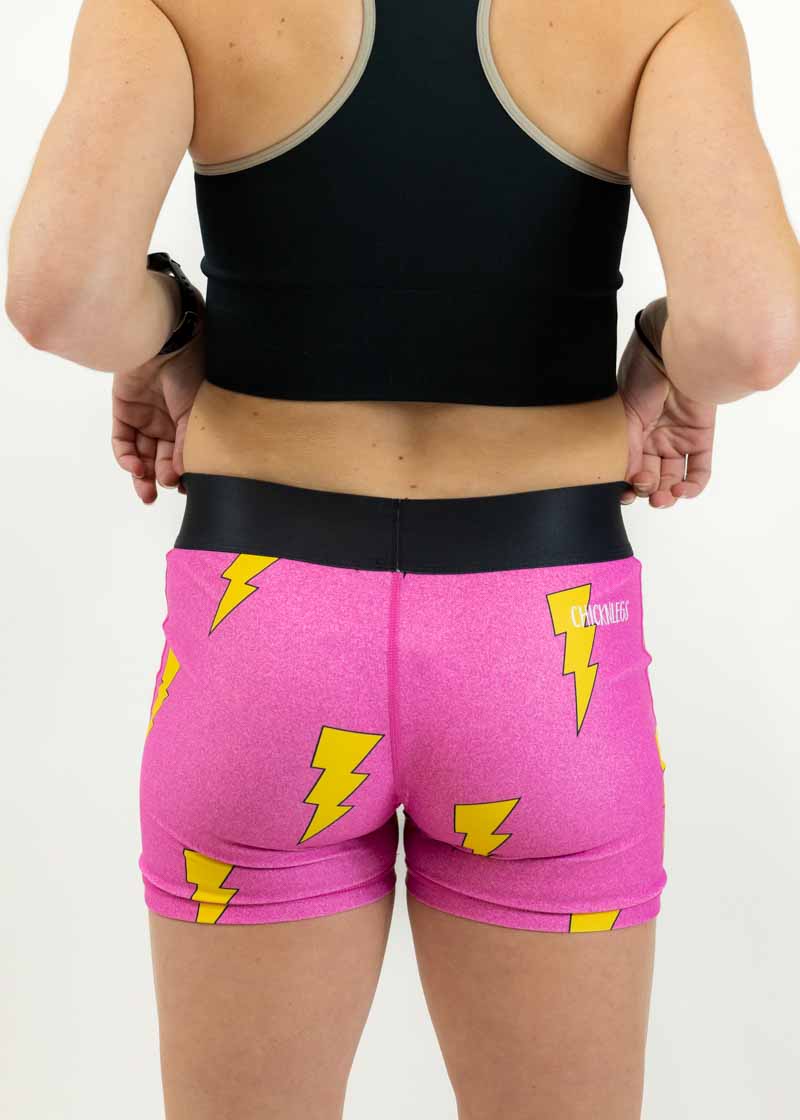 Back view of runner wearing the 3 inch pink bolts compression shorts from ChicknLegs.