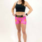 Full body shot of runner wearing the 3 inch pink bolts compression shorts from ChicknLegs.