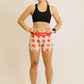 Full body view of the women's 3 inch strawberry compression running shorts from ChicknLegs.