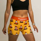 Side view of the women's 3 inch compression traffic cone shorts from ChicknLegs.