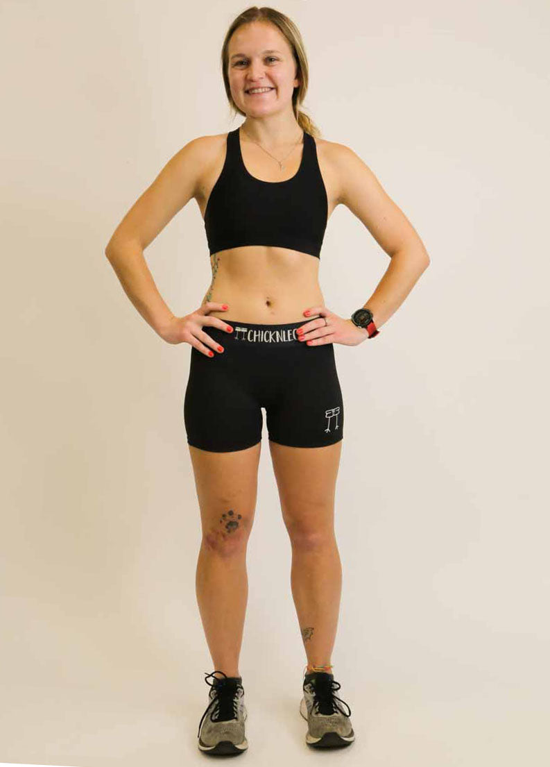 Full body view of runner wearing ChicknLegs black compression shorts.