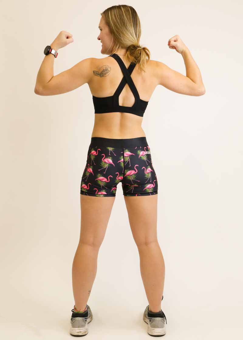Runner flexing arms while wearing the 3 inch flamingo compression shorts.