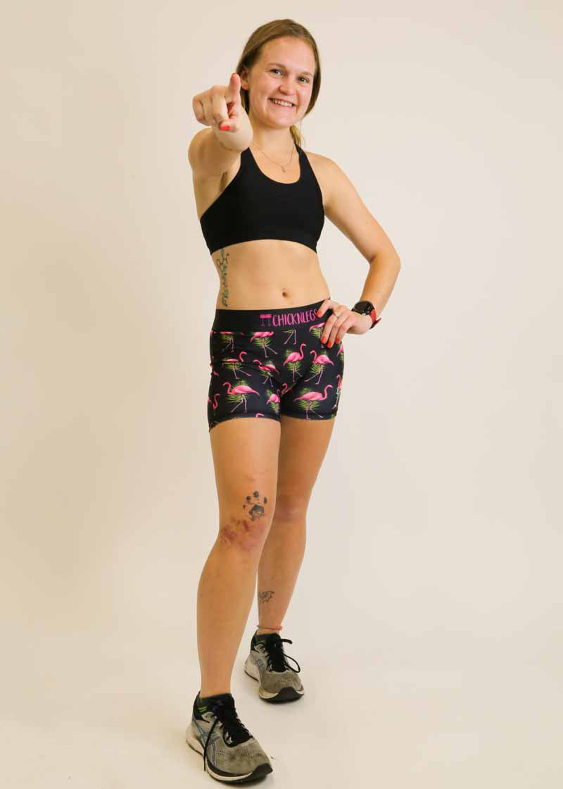 Runner points at the camera wearing the flamingo 3 inch compression shorts.