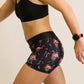 Left side view of the women's 3 inch flamingo compression running shorts.