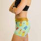 Side view of the ChicknLegs compression running shorts with a green llamas pattern.