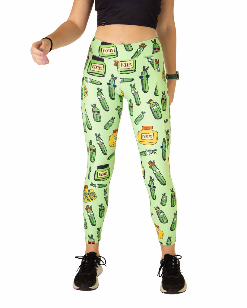 Runner is wearing ChicknLegs in the women's drawstring leggings with pockets in the pickles design. The print has pickles in different shapes and sizes in yellow and green jars.