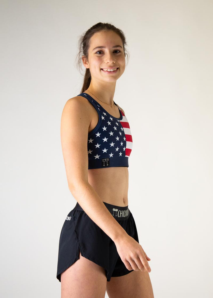 The model is a runner who is wearing Chicknlegs in the women's OG sports bra, in the USA design, facing right.