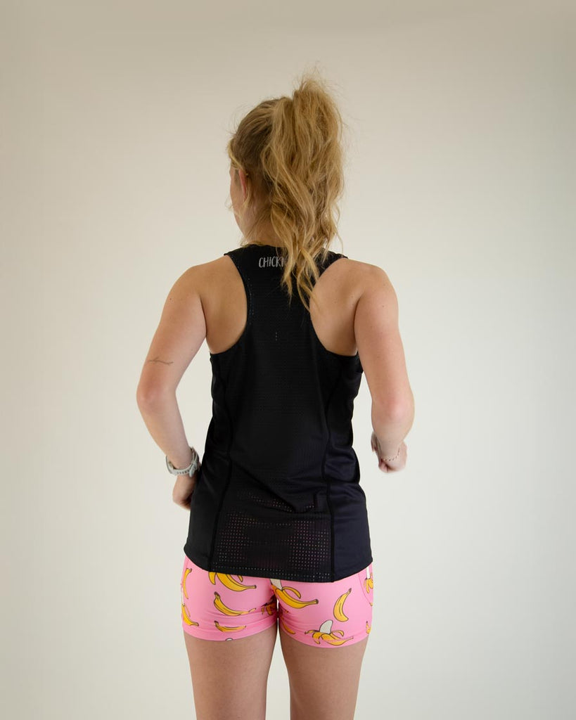 Runner is wearing ChicknLegs in the women's performance singlet in the solid black design. The image shows the back of the singlet.