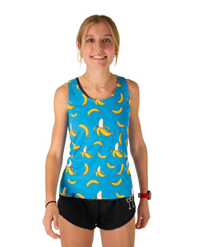 Runner is wearing ChicknLegs in the women's performance singlet in the blue banana design. The print has a solid blue background with yellow bananas all over it.