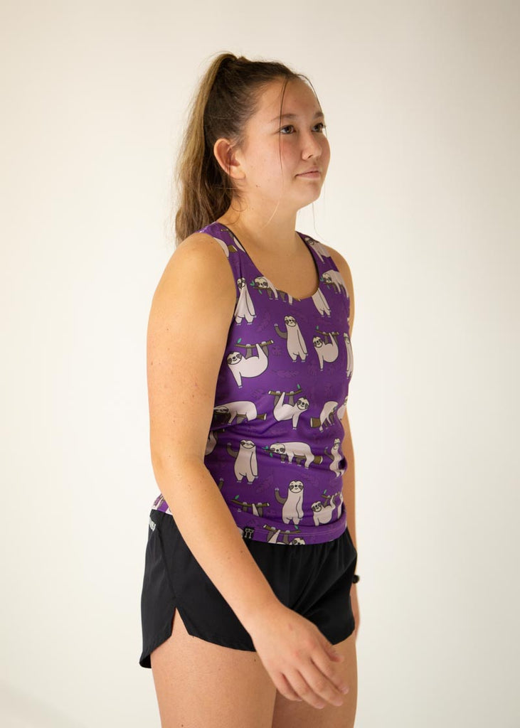 The model is a runner who is wearing Chicknlegs women's singlet in the sloths design, facing right.