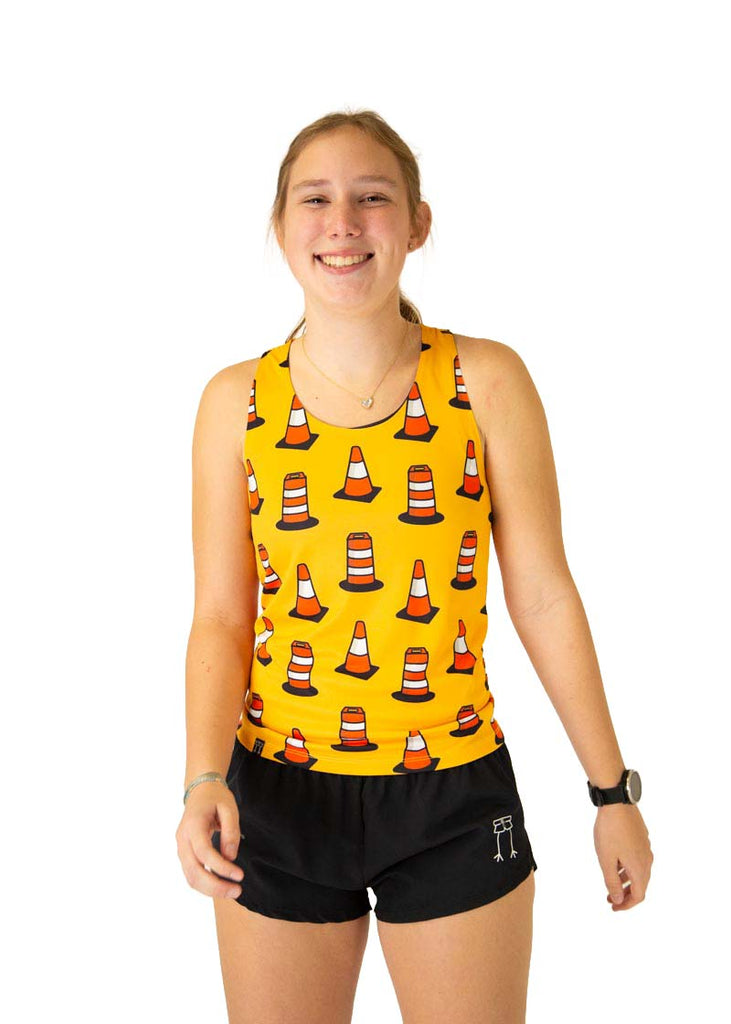 Runner is wearing ChicknLegs in the women's singlet in the traffic cones design, with a yellow orange background with orange traffic cones all over it.