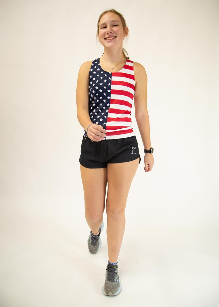 The model is a runner who is wearing Chicknlegs women's singlet in the USA design, facing front and in a walking position.