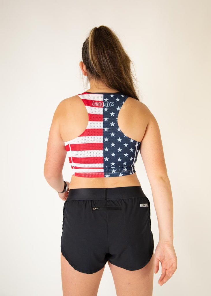 The model is a runner who is wearing Chicknlegs women's pwr USA crop top, facing away from the camera.