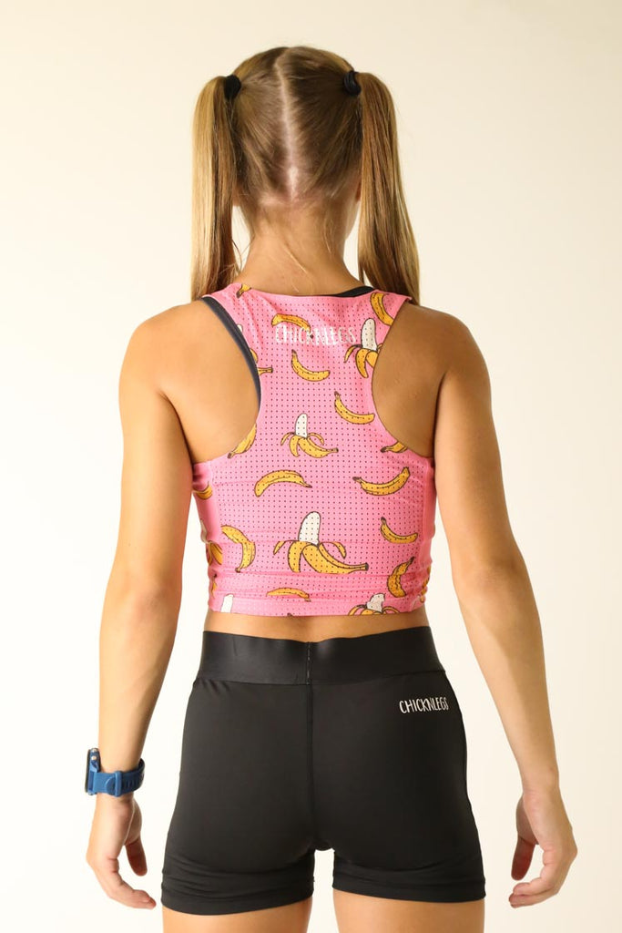 Model is wearing Chicknlegs PWR crop top in the pink bananas design facing back for the behind shot.