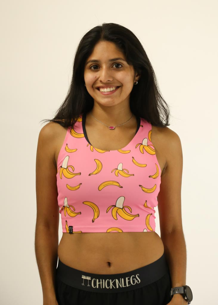 Front view of the women's running PWR crop top in our pink bananas design.