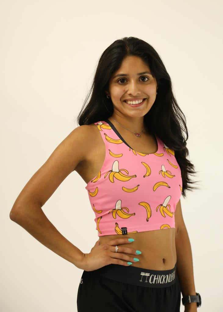 Front view of the women's pink bananas PWR running crop top.