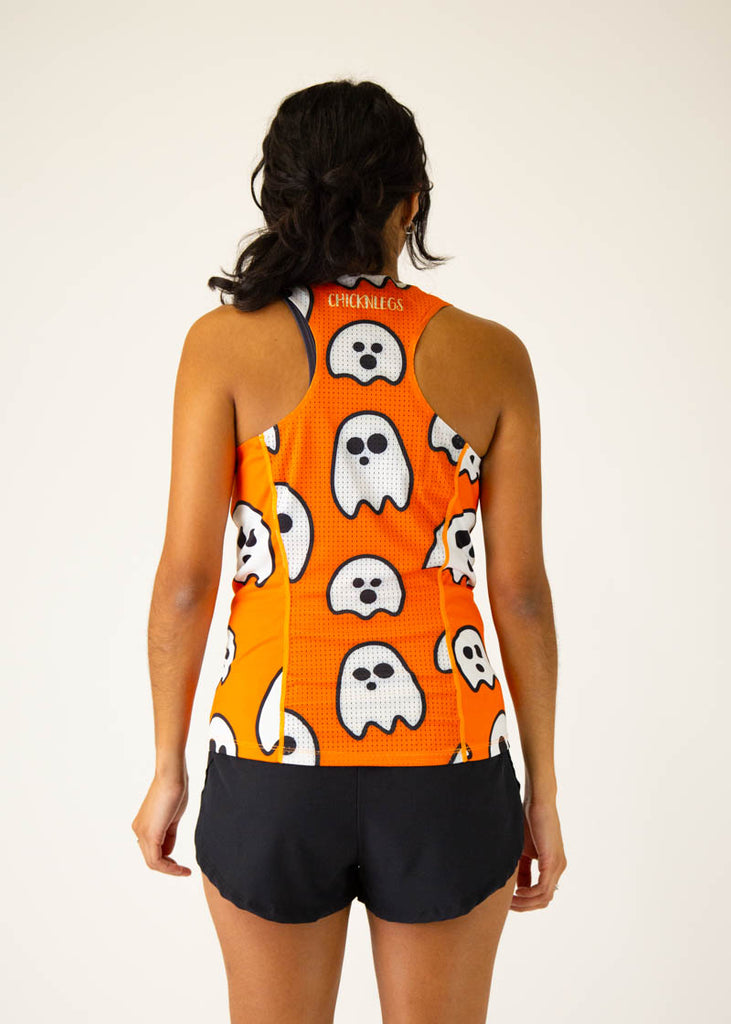 The model is a runner wearing chicknlegs women's runners singlet in the ghost design, facing away from the camera to show the back of the singlet.
