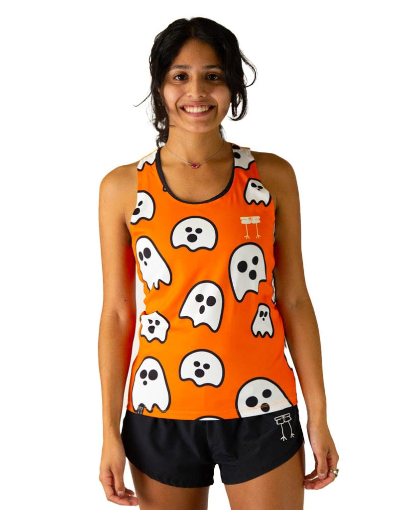 Runner is wearing ChicknLegs in the women's performance running singlet in the ghosts design. Orange fabric background with white ghosts are shown on the print.