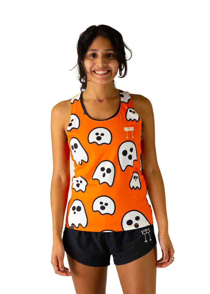 Runner is wearing ChicknLegs in the women's performance running singlet in the ghosts design. Orange fabric background with white ghosts are shown on the print.