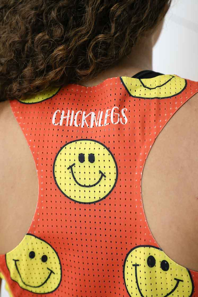 Closeup view of the back perforated mesh panel of the women's smileys running singlet.
