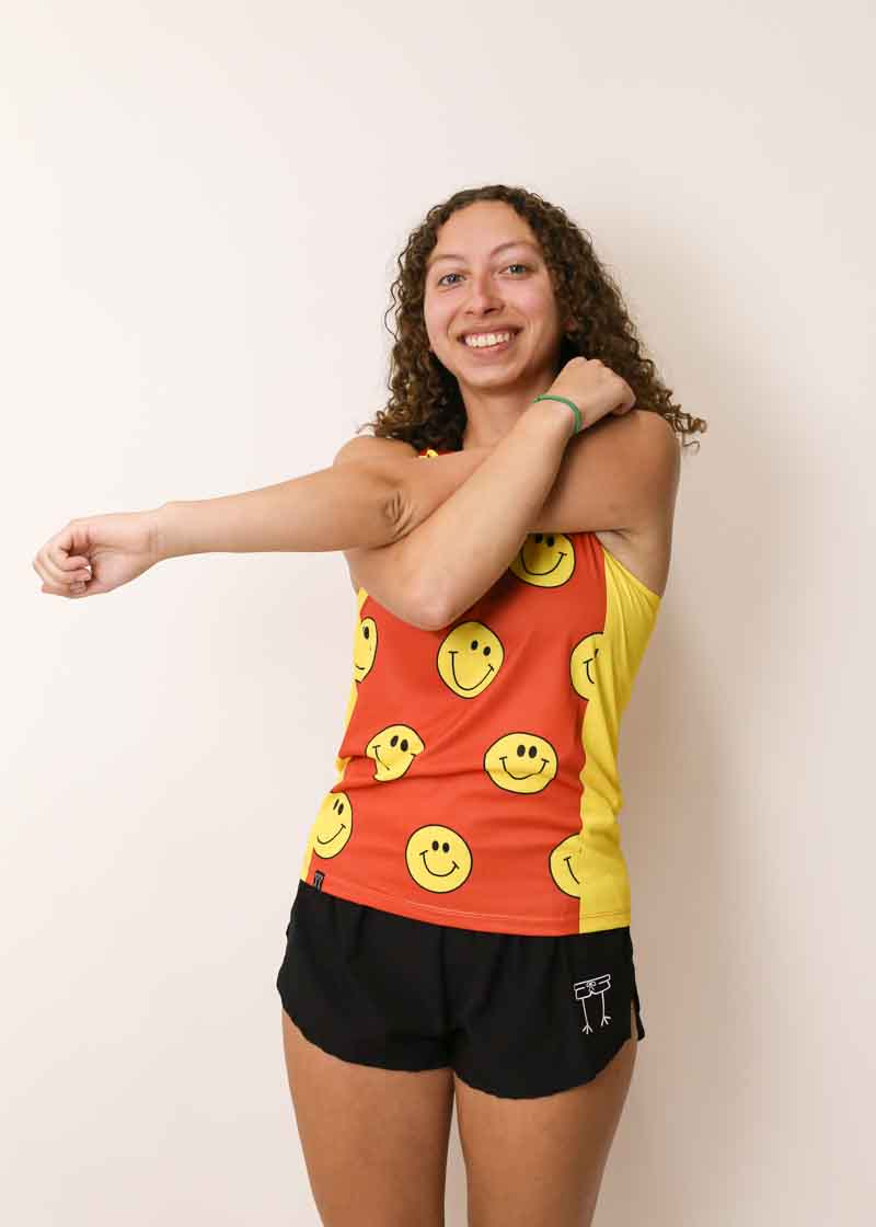 Runner stretching while wearing the smileys running singlet from ChicknLegs.
