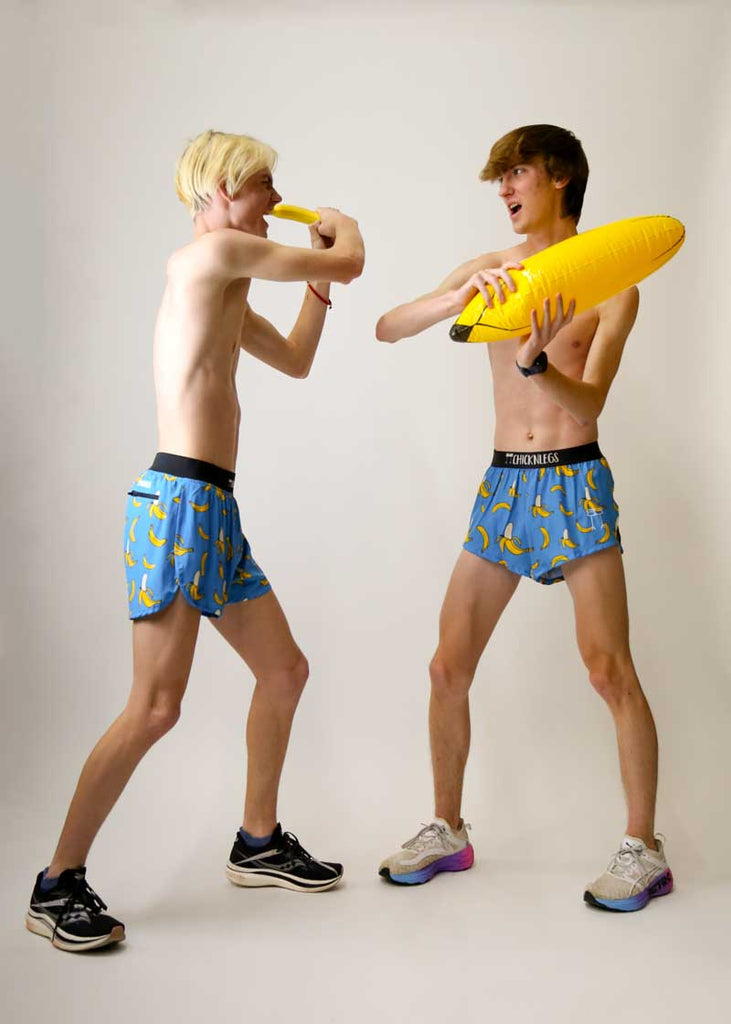 XC runners fighting with inflatable bananas while wearing the blue bananas running shorts from ChicknLegs.