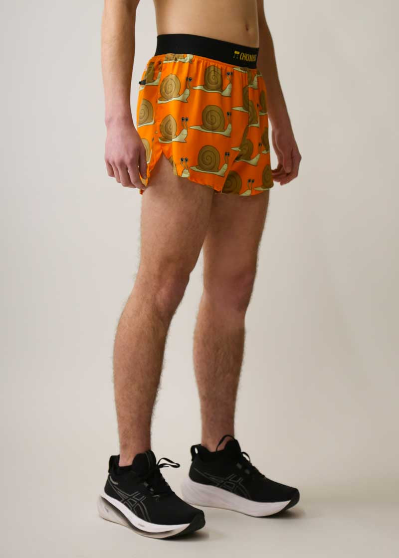 Side view of the men's 4 inch half split shorts with a orange snails design.