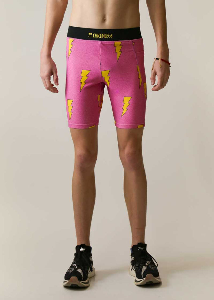 Front view of the men's pink bolts 8 inch half tights.
