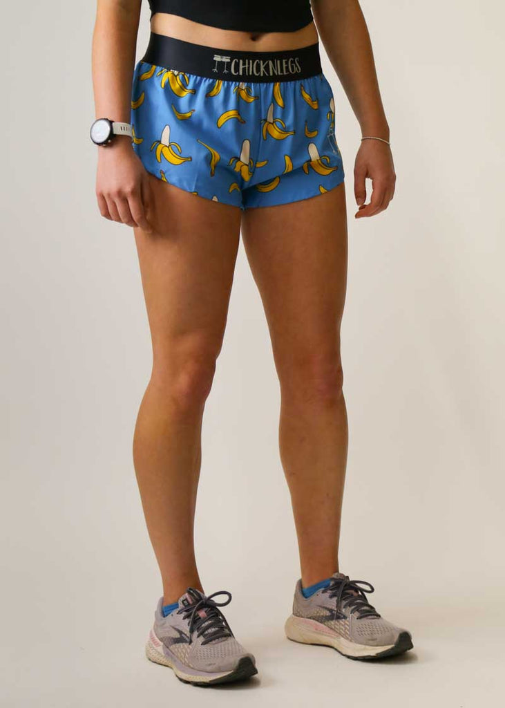 Side view of the women's 1.5" split running shorts in our blue bananas design.