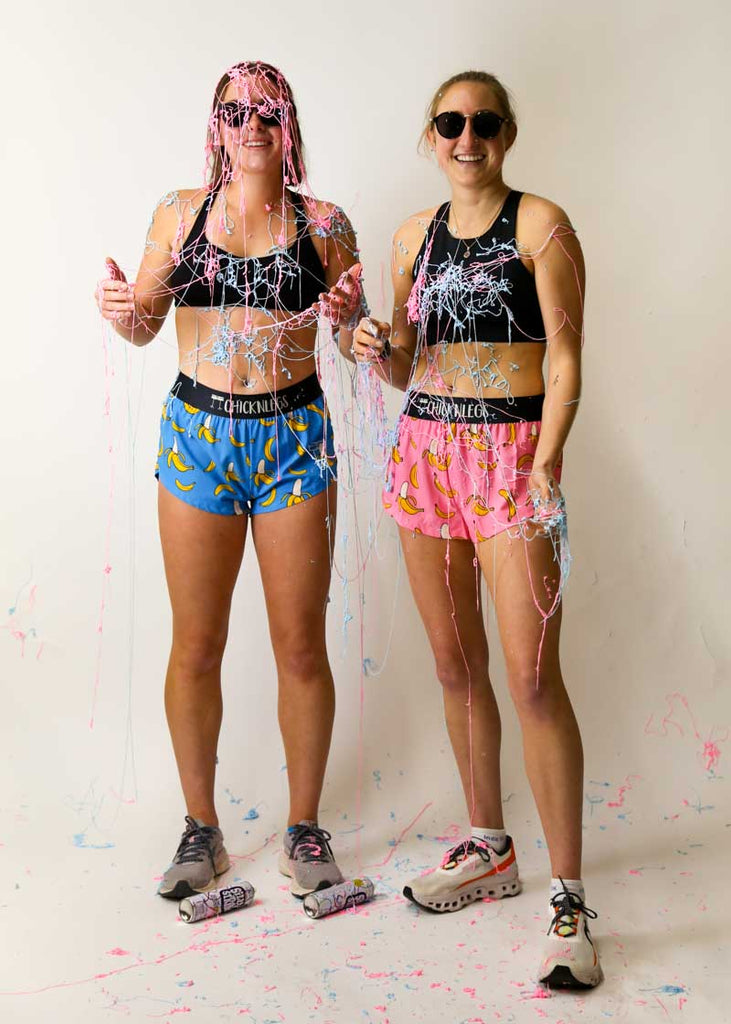 Runners covered in silly string while wearing the banana running shorts.