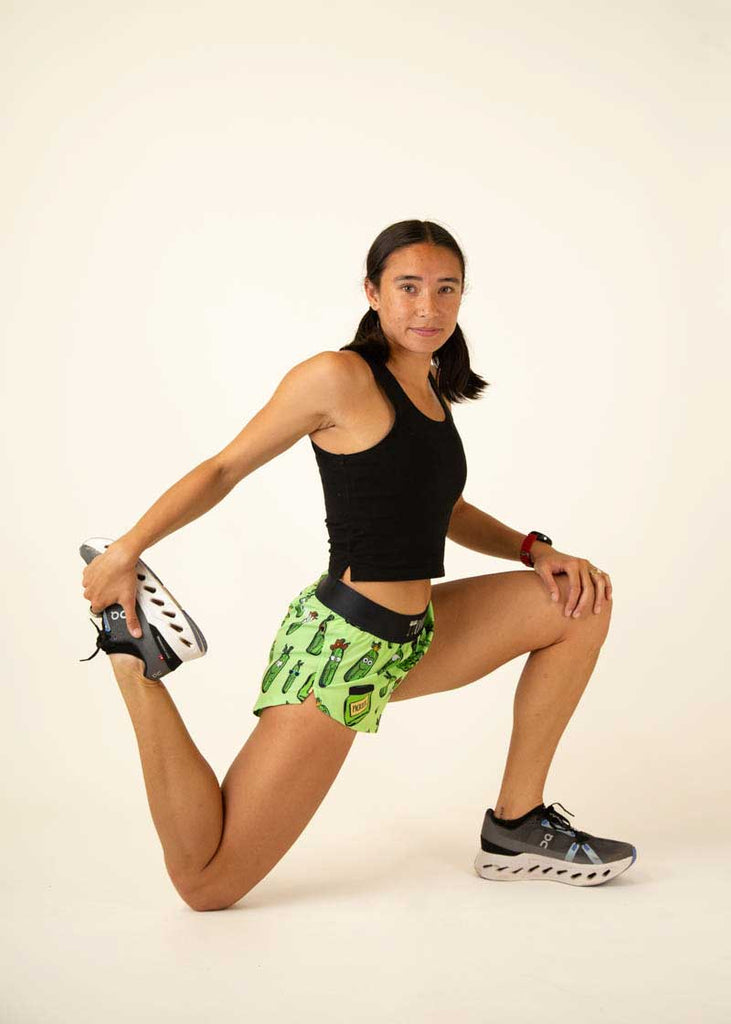 Full body view of the women's pickles 1.5 inch split running shorts.