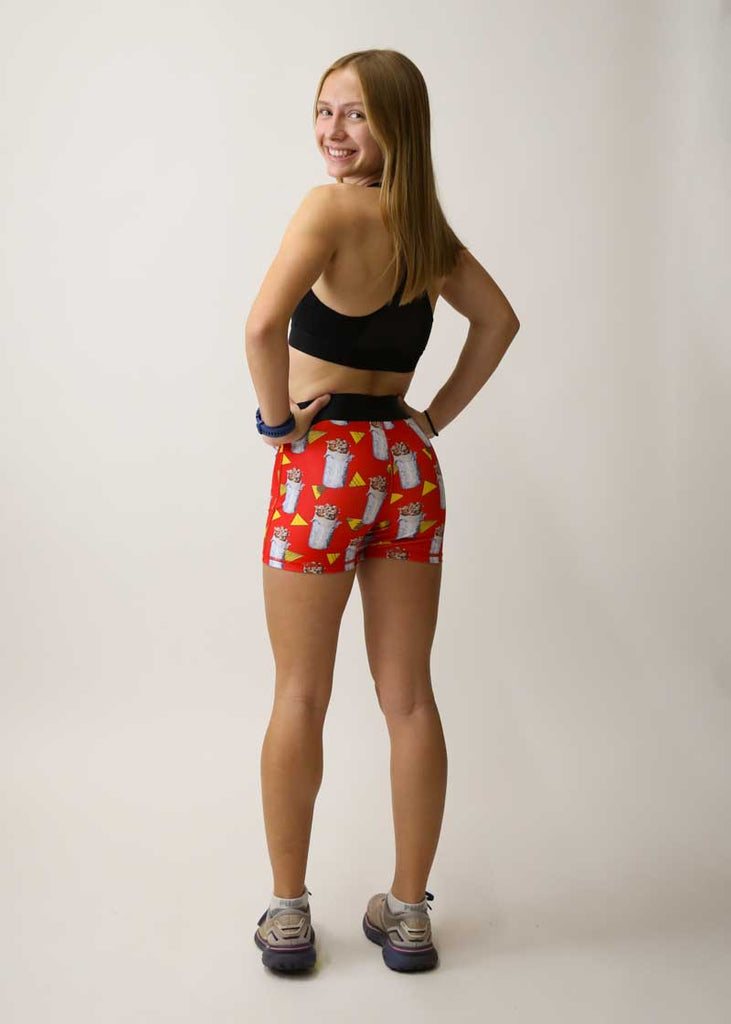 Runner looking over her shoulder while wearing the women's 3" burrito compression shorts.