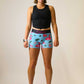Full body shot of the women's blue flamingo compression running shorts.