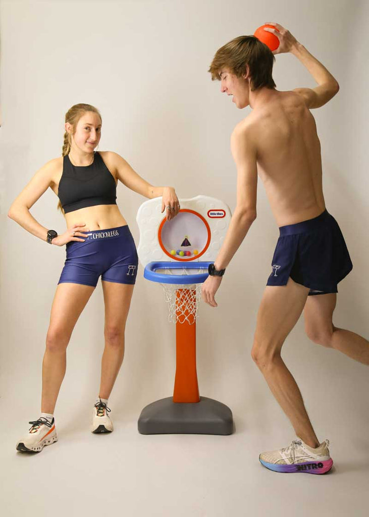 Runners playing with a little tikes basketball hoop in the navy blue running shorts from ChicknLegs.