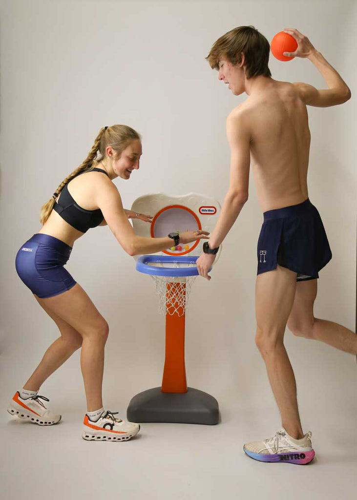 Runners playing kiddie basketball in the men's and women's navy blue running shorts.