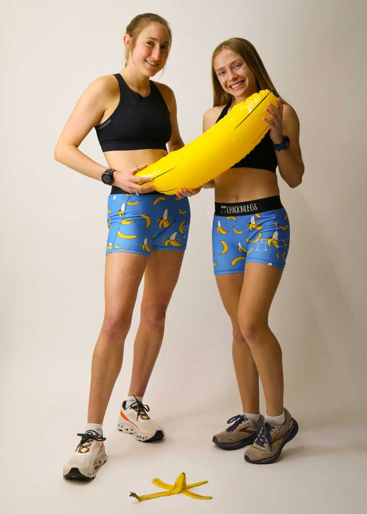 Runners posing in the women's blue bananas running shorts and inflatable banana.