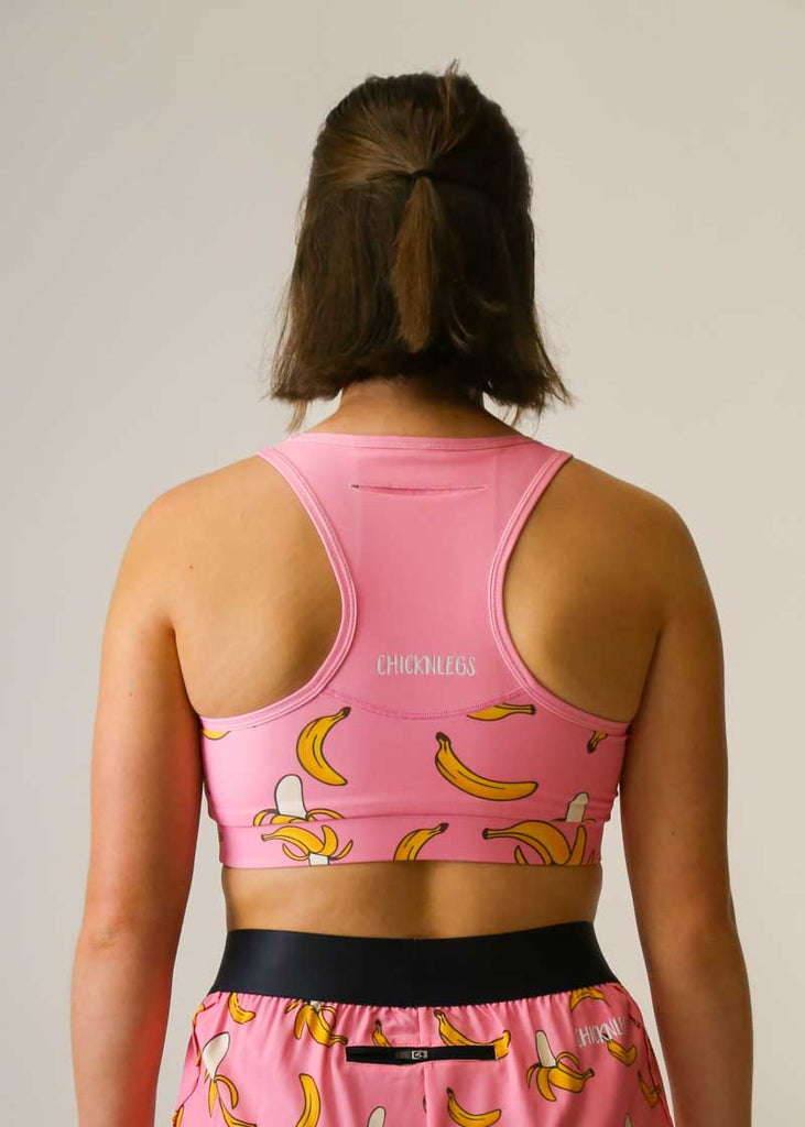 Back view of the pink bananas OG running sports bra with phone pocket.