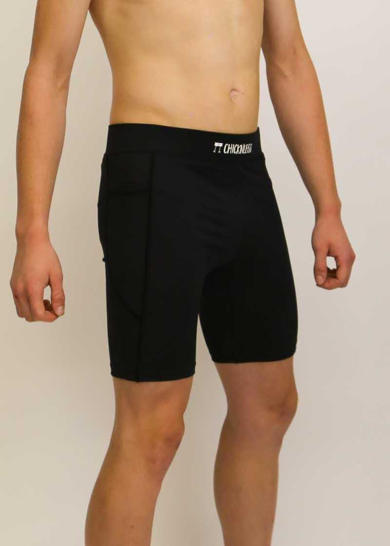 Side view of the men's 8 inch black half tights.