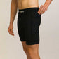 Side view of runner putting phone in the pocket of the black half tights.