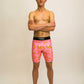 Runner wearing the men's 8 inch compression half tights with a pink bananas design.