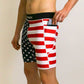Side view of runner putting a phone in the pocket of the men's 8 inch USA half tights.