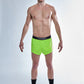 Full body view of the ChicknLegs men's 2 inch neon green split running shorts.
