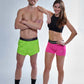 Group photo of the ChicknLegs men's 2 inch neon green split shorts and the women's neon pink 3 inch compression shorts.