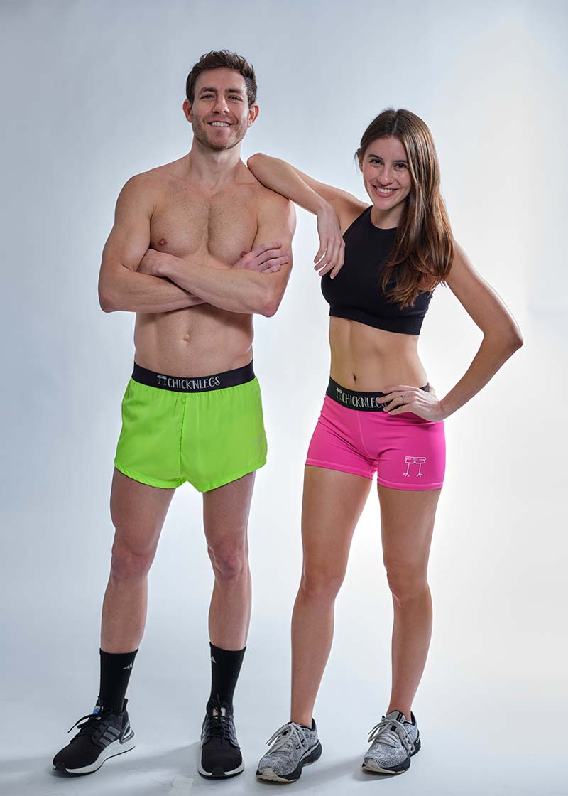 Group photo of the ChicknLegs men's 2 inch neon green split shorts and the women's neon pink 3 inch compression shorts.