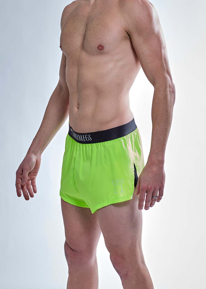 Side logo view of the ChicknLegs men's 2 inch neon green split running shorts.