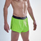 Side split view of the ChicknLegs men's 2 inch neon green split running shorts.